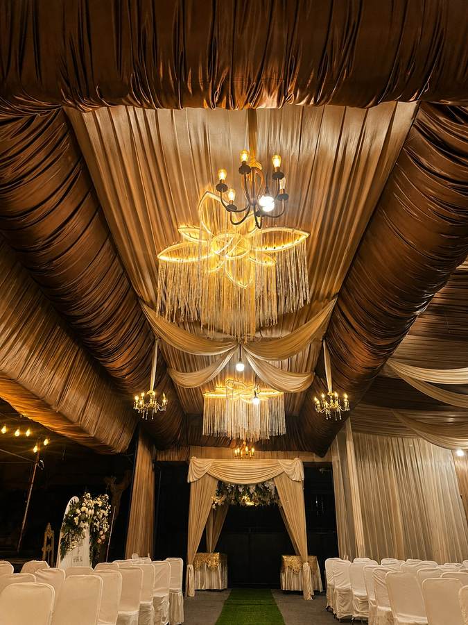 Plafon drapery emas dengan deretan lampu gantung kristal